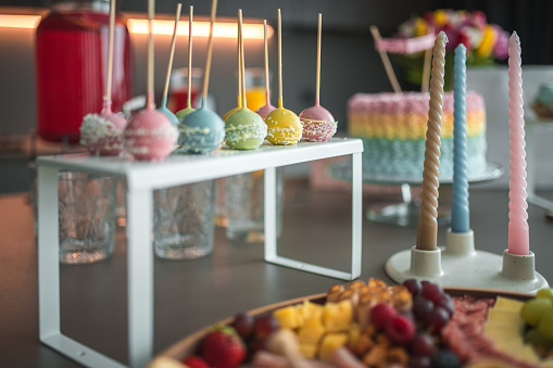 A sweet confectionery display featuring a variety of pastel cake pops, sprinkled and ready for the baby shower revelry.