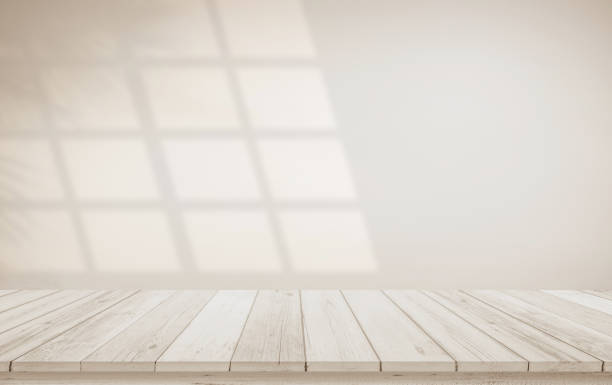 istock Minimalistic abstract gentle light beige background for product presentation with light and shadow of window and leaf curtains on wall. Pastel cream watercolor concrete wall old on floor wood parquet. 2006313676