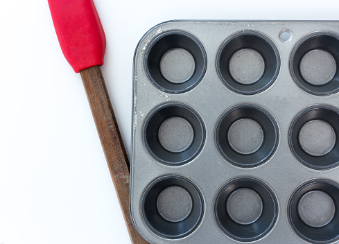 Muffin Tin Close Up with Red Spatula