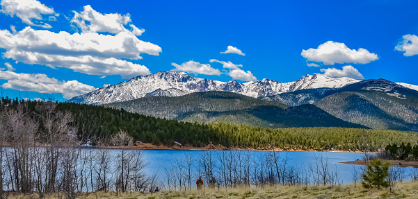 Pikes Peak panorama. Snow-capped and forested mountains near a mountain lake, Pikes Peak Mountains in Colorado Spring, Colorado, USA
