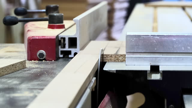 The detailed process of cutting wood on a tilting circular saw