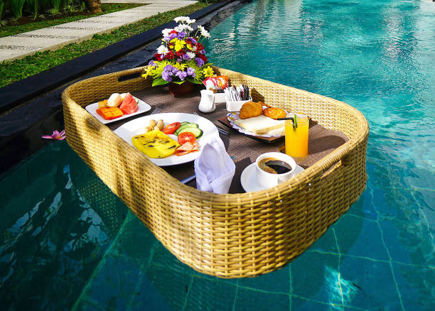 istock Set of floating breakfast tray in swimming pool. Breakfast in swimming pool, floating breakfast set in tray 2006394896