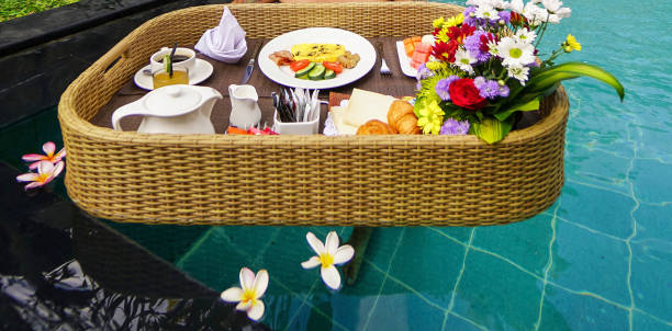 istock Set of floating breakfast tray in swimming pool. Breakfast in swimming pool, floating breakfast set in tray 2006394908