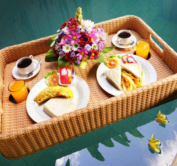 istock Set of floating breakfast tray in swimming pool. Breakfast in swimming pool, floating breakfast set in tray 2006395986