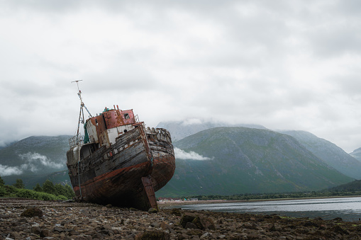 Old boat of Caol shipwreck in Corpach near Fort William on a rainy day.Tourism,scottish landmarks. High quality photo
