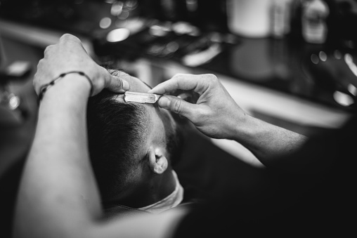 Barber Giving A Haircut in His Shop