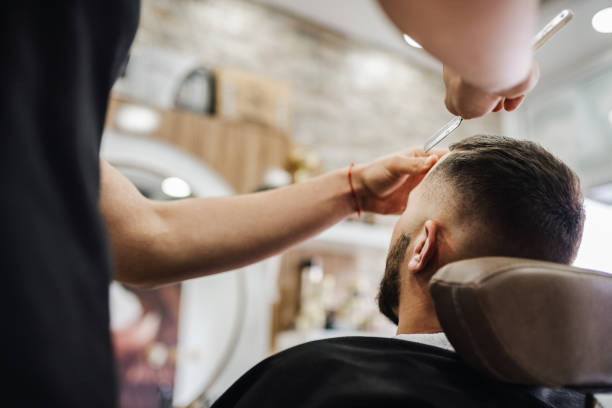 istock Barber shaves the beard of the client 2006424249
