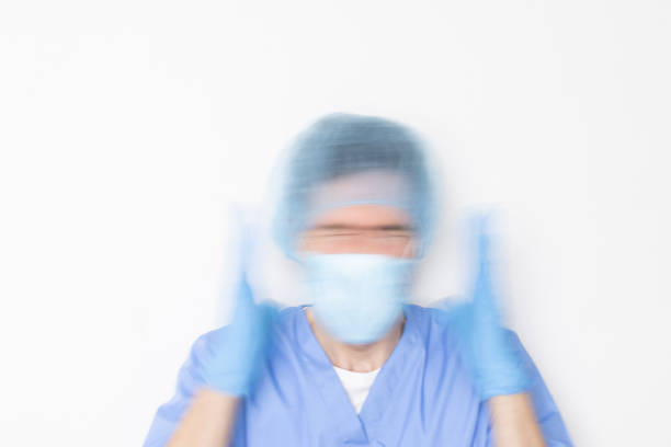 motion blur of an unrecognizable doctor in crisis due to overwork and emotional stress.nurse with panic attack and work anxiety.medical emergency and urgency service overflowed.
