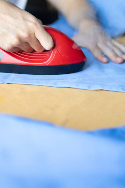 istock medical worker ironing uniform with a steam iron.A doctor daily routine. 2006494104