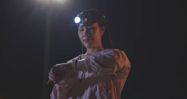 istock Young woman athlete use smart watch checking heart rate and use a flashlight on head while exercise at night 2006545225