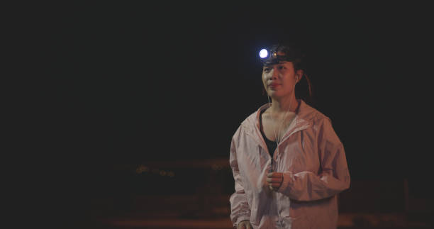 Noctourism & family adventure in nature. Father & little daughter exploring night sky using flashlight to find constellations. Child development, astronomy & sharing family moments outdoors.