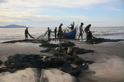 fishermen from the Javanese village of Banda Aceh 10/29/2019, Repair their fishing nets after finishing fishing in the sea, this is done to keep the nets in good condition to be used again the next day.