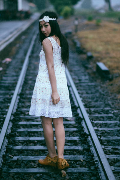 a man walking on rails, a view of feet walking on railroad tracks. High quality photo
