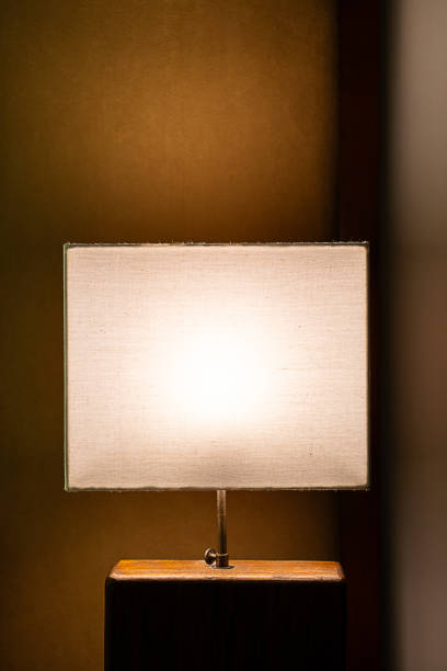 istock Glowing lamp on nightstand In the evening. 2006567993