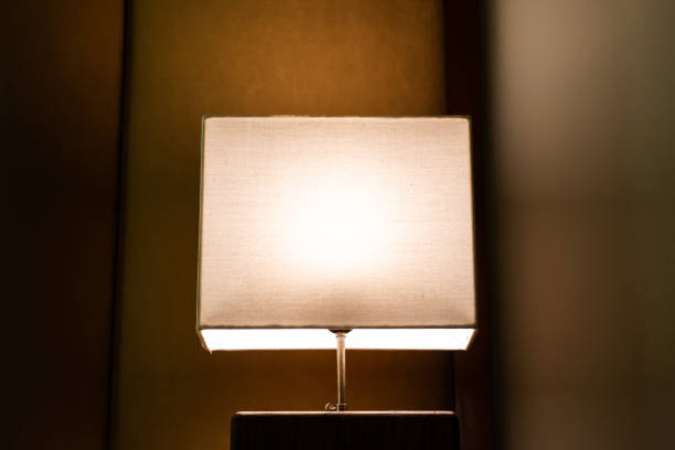 istock Glowing lamp on nightstand In the evening. 2006573116