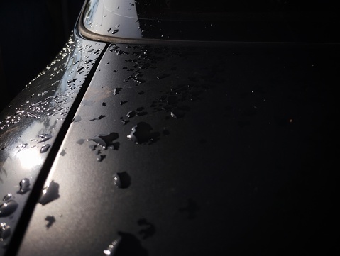 Rainwater on the black car body