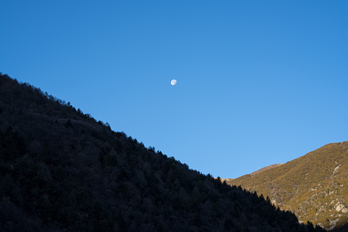 The Mountains and the Moon at Sunrise