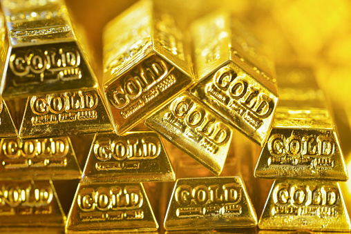 Soft focus of stacking gold bars with the golden reflect light. Gold is hard commodity good, risk asset, tangible value that used to be gold reserve, fund reserve,