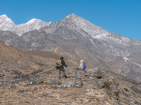 Hikers Advancing Along the Mountain Ridge