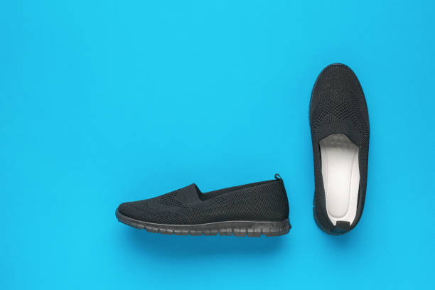istock Women's comfortable shoes with white arrows on a blue background. 2006603207