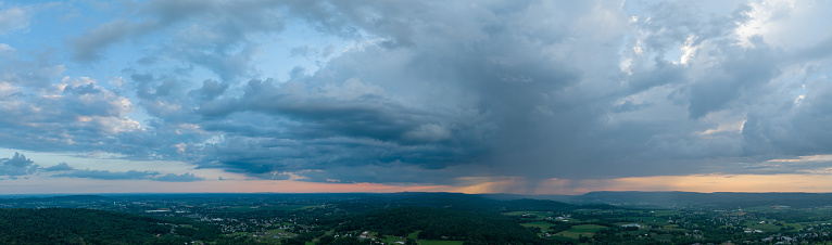 A beautiful panoramic aerial view of clouds and the sunset over the beautiful green farmland of Lancaster County, Pennsylvania.