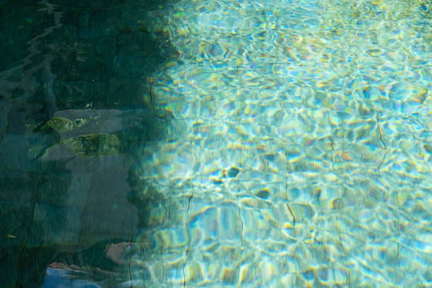 Water in swimming pool reflecting sunshine.