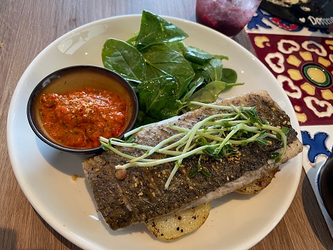 In Immerse yourself in a culinary delight with our perfectly grilled sea bass fillet. Each tender and flaky fillet is expertly seasoned and grilled to perfection, capturing the essence of the ocean in every bite. .