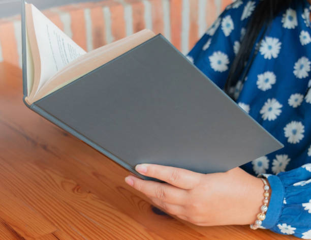 istock woman reading book at table 2006787750