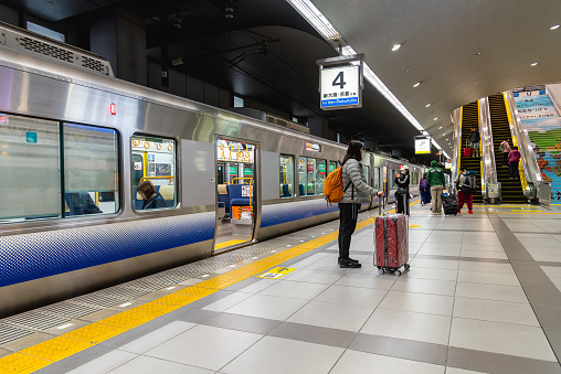 Osaka, Japan - November 20, 2023 - JR Kansai airport station, passengers transferring from JR train line to Kansai international airport.