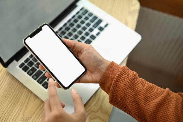 istock Woman hands using mobile phone at working desk. Empty screen for advertising and creative design 2006808482
