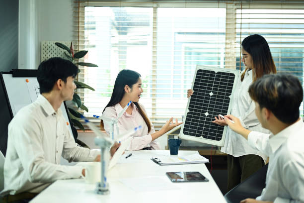 istock Group of engineers developing solar panel for alternative energy at meeting. Green alternative energy concept 2006810054