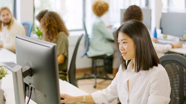 istock Asian woman working happily in a coworking space 2006851181