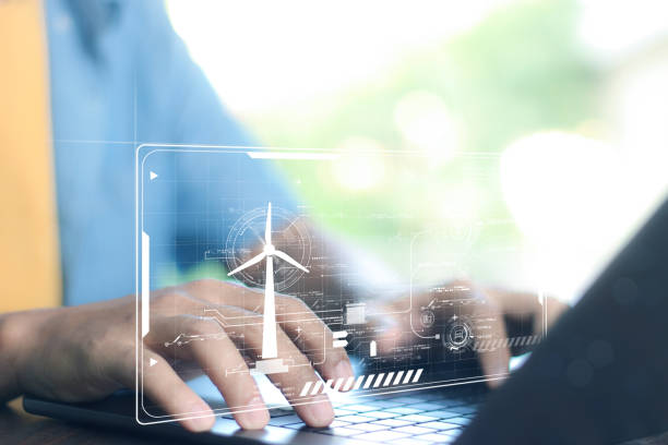 istock Businessman using laptop with Alternative energy for the future concept,Wind turbines change wind energy into electrical energy. 2006876193