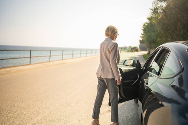 istock Businesswoman getting into car after work 2006888730