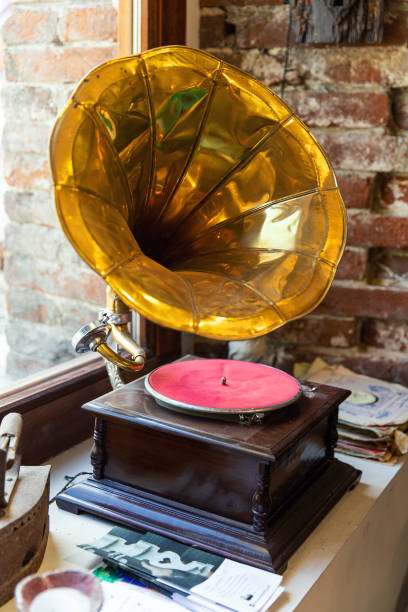 istock Vintage gramophone stands on windowsill near the window 2006893363