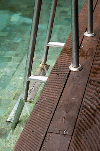 Outdoors swimming pool ladder. Summery vacations.
