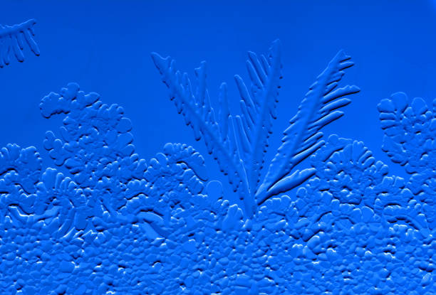 Drawings of ice on blue glass. Abstract background