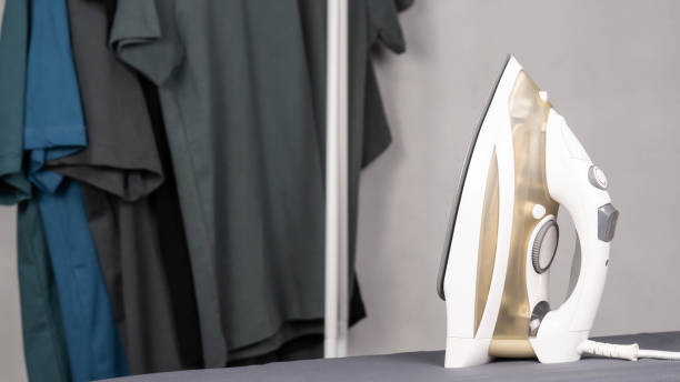 istock Electric steam iron. Housework concept. Clean clothes on the ironing board. 2006985579