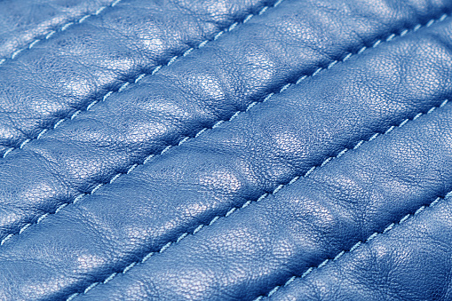 Macro shot leather texture background. Part of blue perforated leather details. Perforated leather texture background. Texture leather