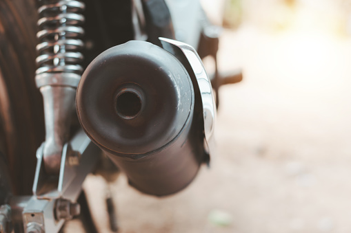 Motorcycle exhaust pipe emits carbon gas.