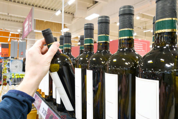 istock Bottle of white wine on hand in shop 2007044962