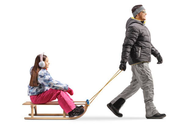 istock Man pulling a girl on a wooden sled 2007061494