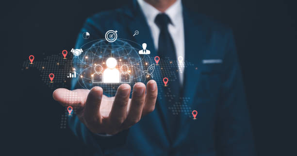 Employing CRM, the businessman manages global customer networks, leveraging technology for data exchanges and development, context of customer service, banking, and strategic business initiatives.