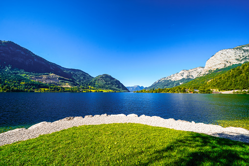 View of the Grundlsee and the surrounding landscape. Idyllic nature by the lake in Styria in Austria. Mountain lake at the Totes Gebirge in the Salzkammergut.