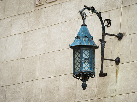 Antique lantern on a stone wall