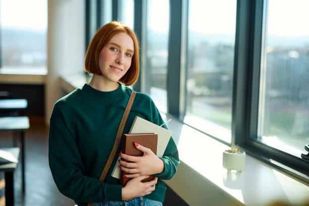 istock Happy female college student in lecture hall looking at camera. 2007095692