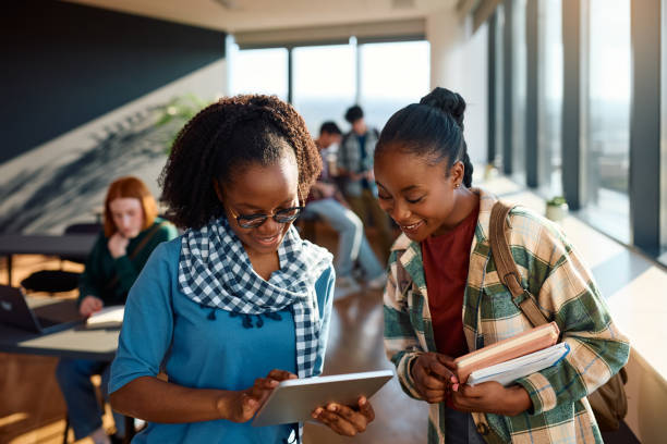 istock Happy black female students using digital tablet in the classroom. 2007099405