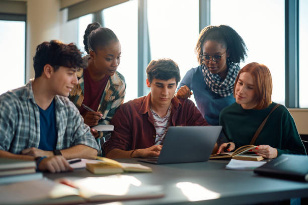 istock Multiracial group of students e-learning on laptop at the university. 2007100460