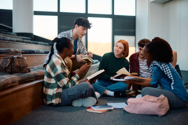 istock Young happy college friends studying together in lecture hall. 2007100973
