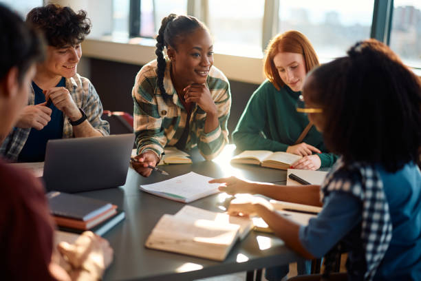 istock Happy black student and her college friends learning together in the classroom. 2007101496